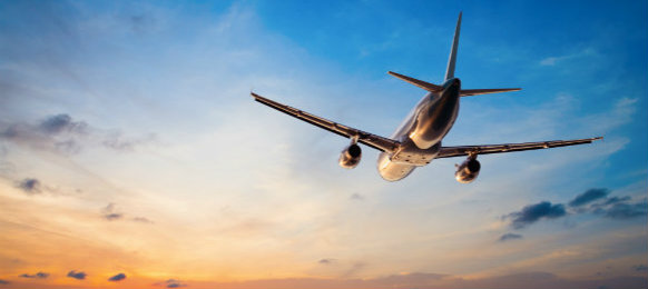 airplane flying during sunset