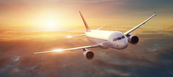 Airplane in the sky at sunset