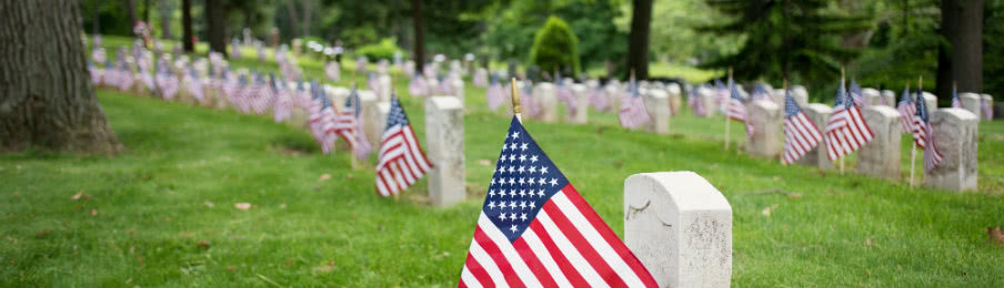 Woman holding an American flag while sitting in the car.