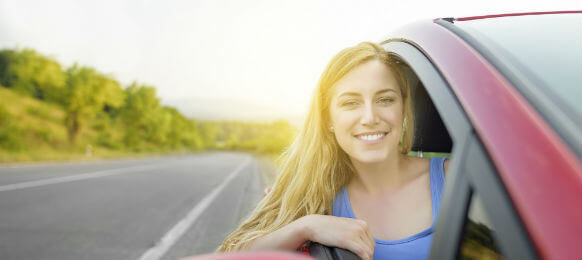 beautiful woman driving a car hire on a country road