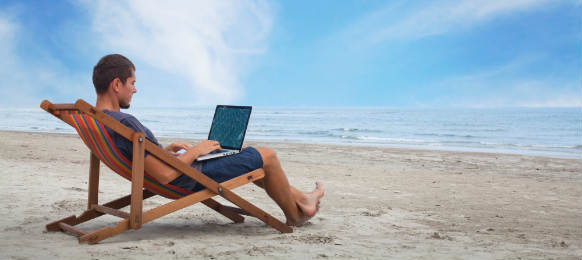 businessman working with computer on the beach