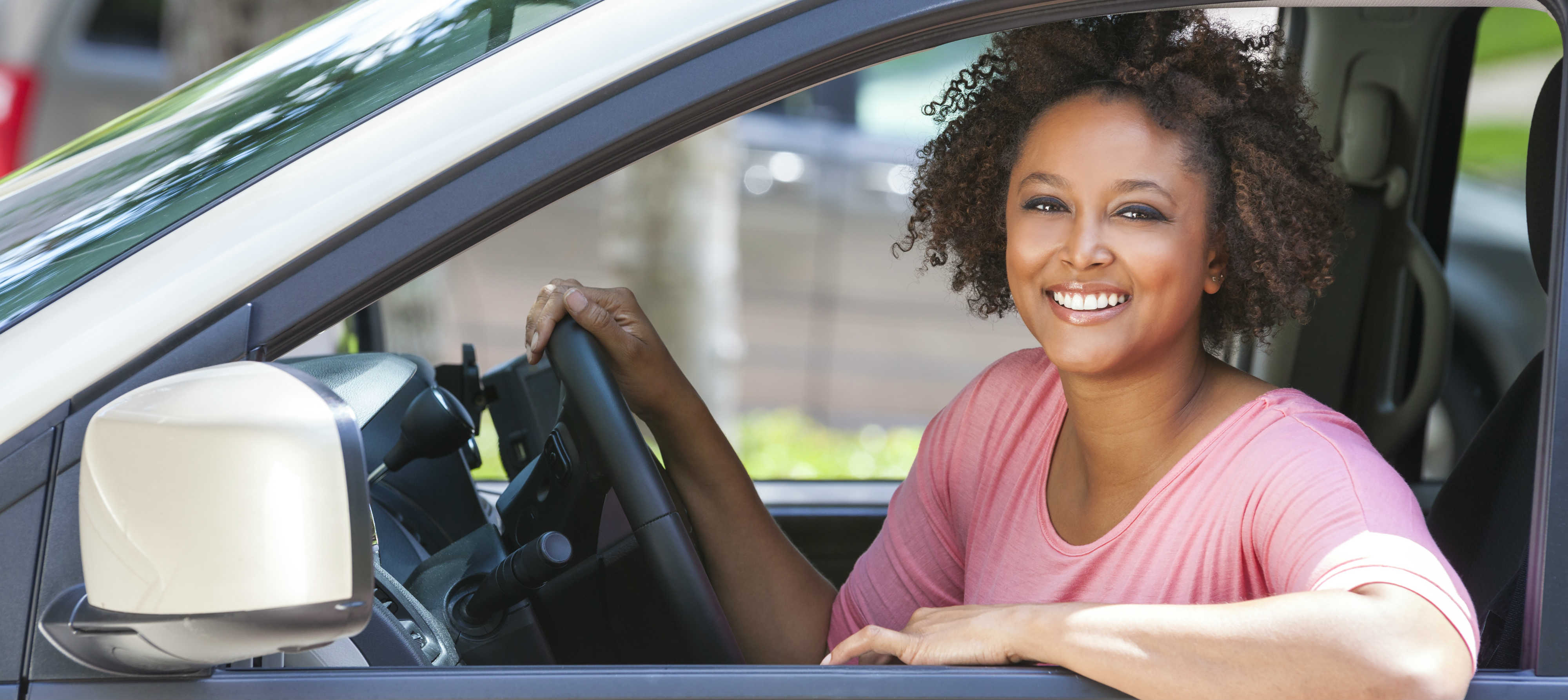 woman in pink enjoying her car rental