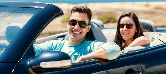 couple inside a blue convertible car rental