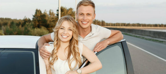 lovely couple posing near their white car