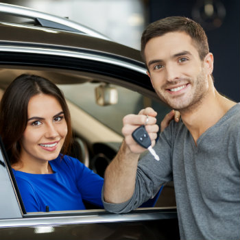 couple happily renting a car