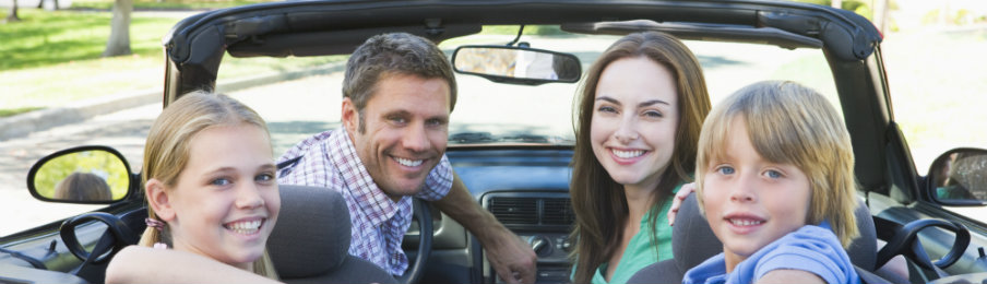 happy family riding a red car