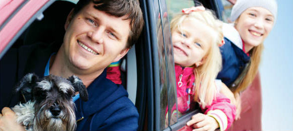 family with a dog in the car