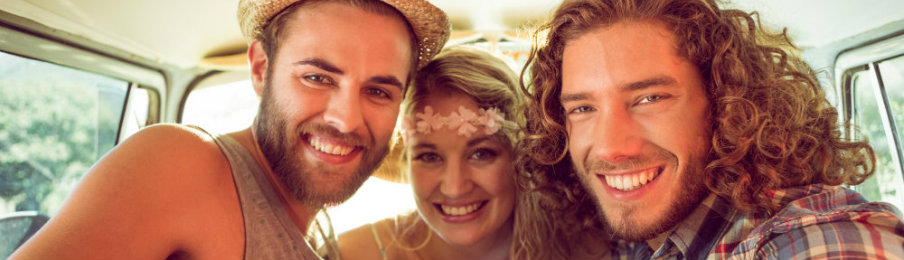 happy friends inside their rental vehicle