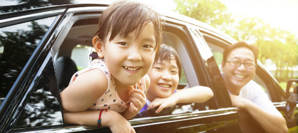happy children and a man looking out of the car hire window in northwich