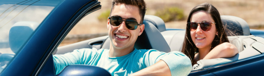 happy couple in a blue convertible car