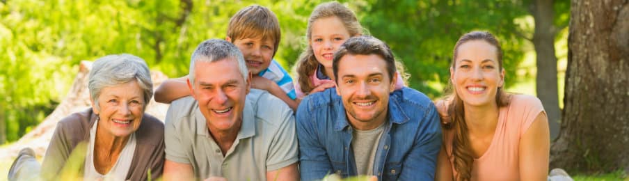happy family together with grandparents in the park
