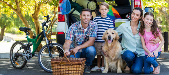 happy family getting ready for road trip on a sunny day