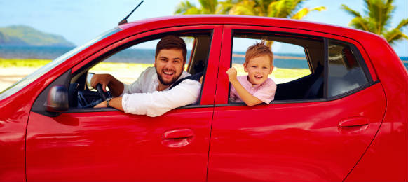 happy father and son traveling a car rental on summer vacation