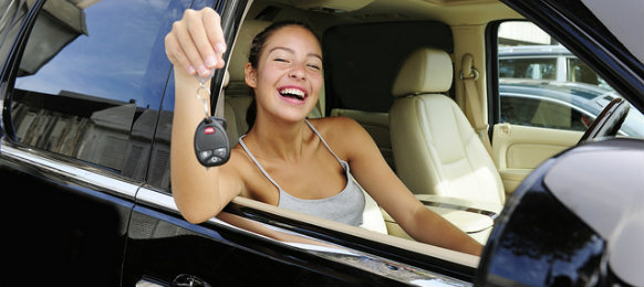 happy woman showing her car key