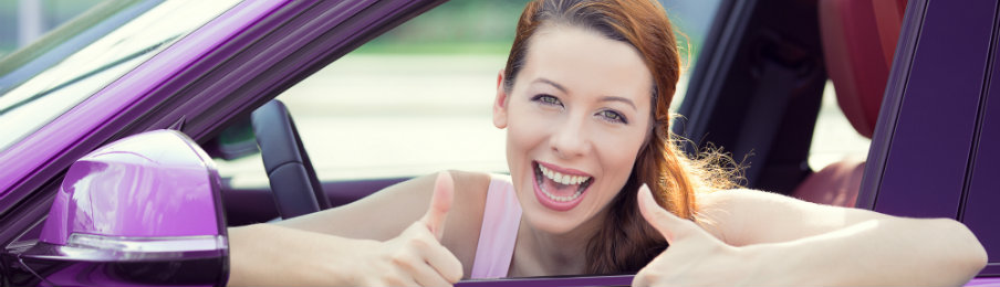 happy woman in a purple car rental