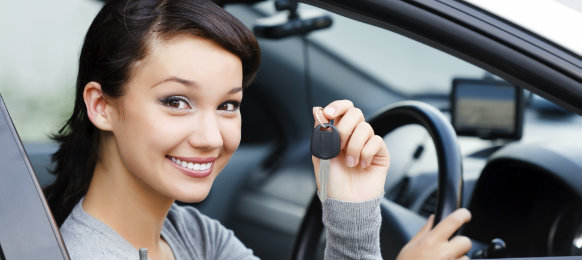 happy woman ready to drive her new car