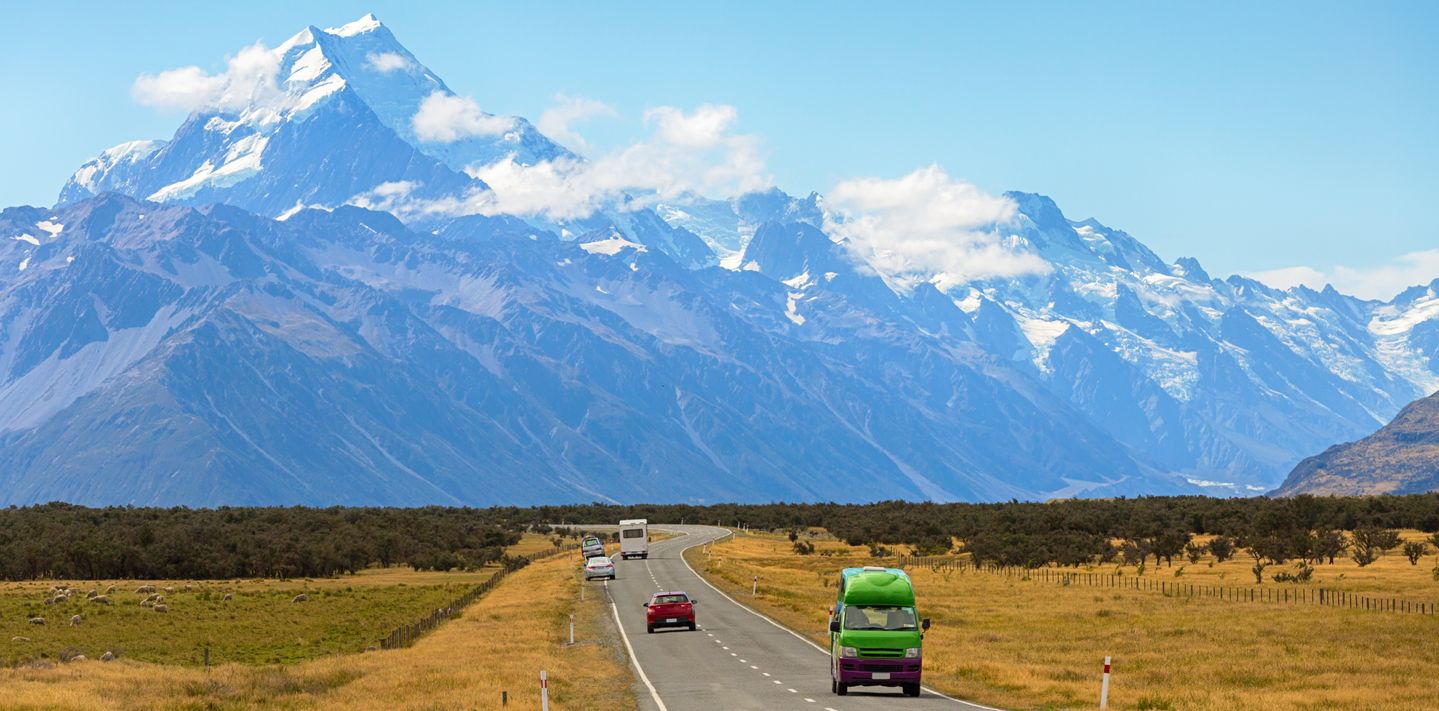 Cars and campervans on a highway in Mount Cook, New Zealand.