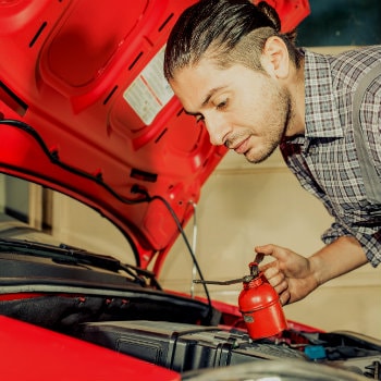 Mechanic fixing and checking a rental car