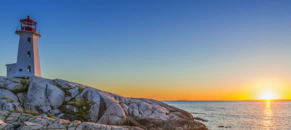 Peggys Cove Lighthouse at sunset in Nova Scotia, Canada