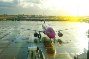 Red airplane parked at Luton London airport, UK