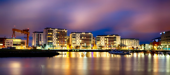 skyline at night from river lagan in belfast city, norther ireland