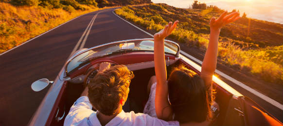 romantic couple driving on beautiful road at sunset