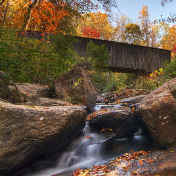 rose creek flows below elders mill covered bridge