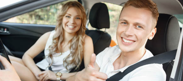 smiling couple inside the car rental