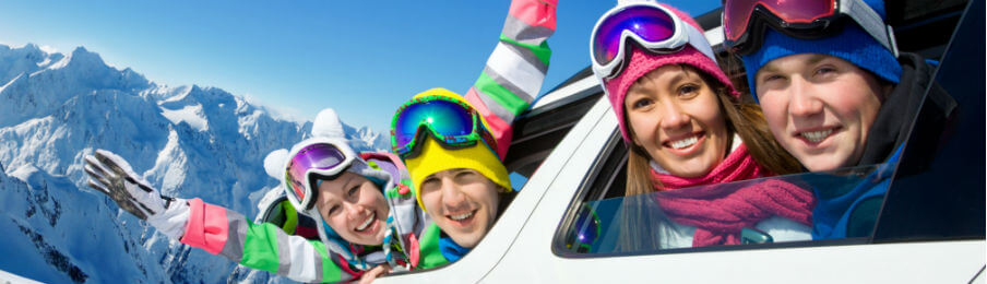 happy family on a winter trip riding a car rental