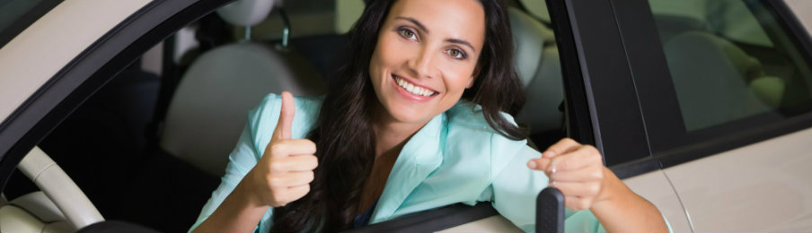 smiling woman holding car key