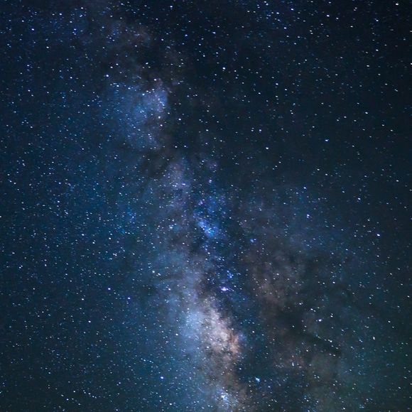 Night sky showing stars and a nebula.