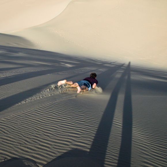 Sandboarding in the sand dunes.