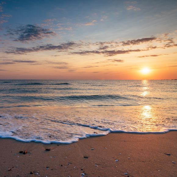 Waves hitting the shore at sunset at Eighty Mile Beach.
