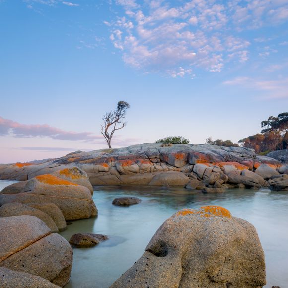 Orange hued granite boulders at the Binalong Bay, Bay of Fires.