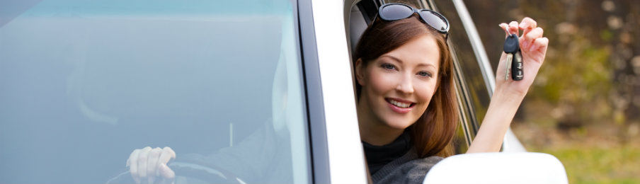 successful woman showing off her car key