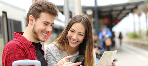 tourists tracelers consulting gps and guide in a train station