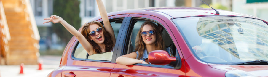 two women enjoying their drive in a reliable car rental