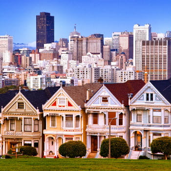 Victorian houses in San Francisco skyline at Alamo Square