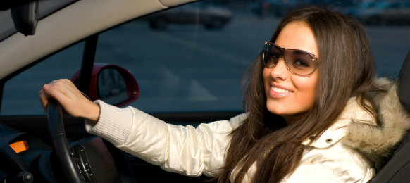 woman in winter outfit driving a car hire