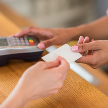 Woman paying car rental bills at the counter