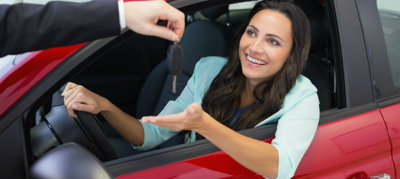 A happy lady receiving her car key