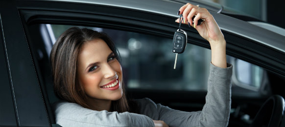 woman smiling and her holding her car key