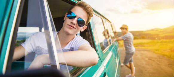 young hipster friends on road trip with their car rental