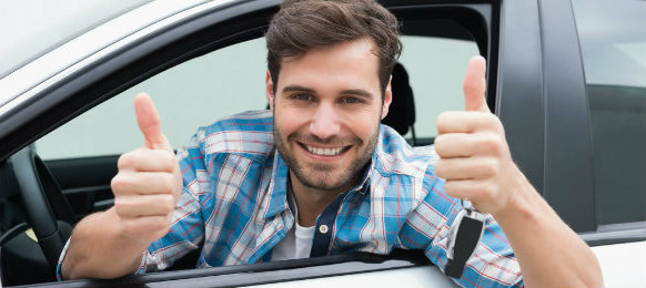 cool guy making a thumbs up sign inside his car