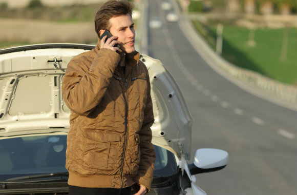 adult-guy-calling-roadside-assistance-for-his-breakdown-car-dp