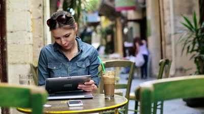 pretty-woman-with-tablet-computer-sitting-in-cafe