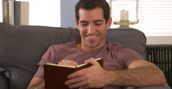 man-writing-in-his-journal-dp