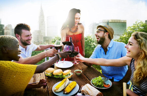 friends enjoying great food on a rooftop in new york