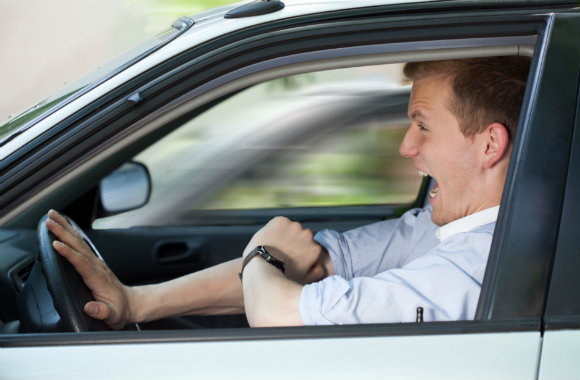 man driving his car fast