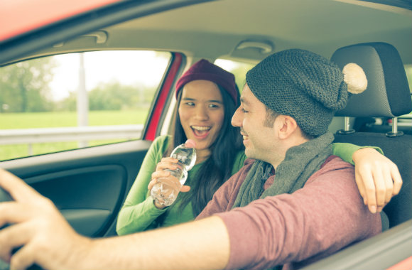 woman singing to her man in the car